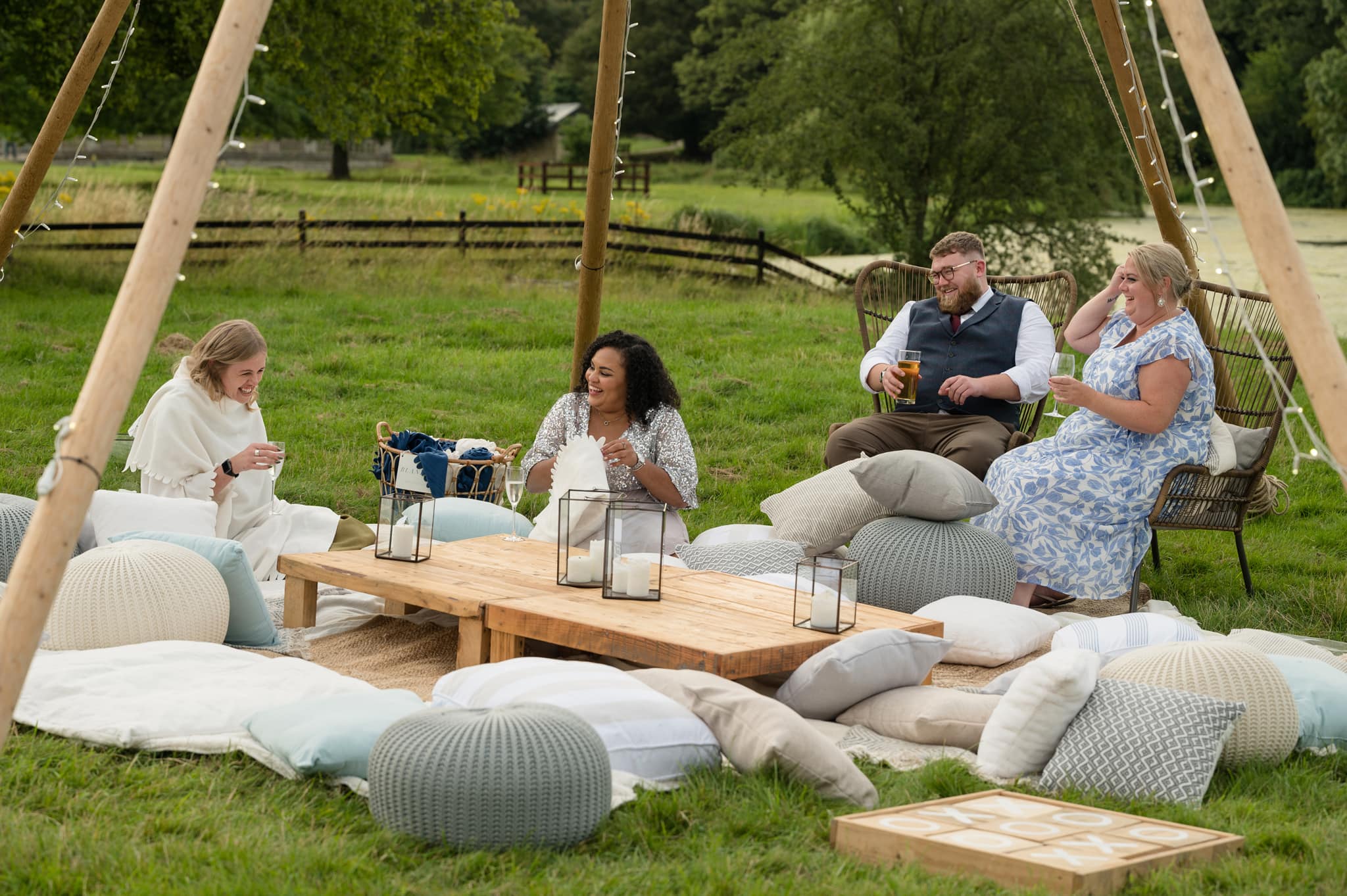 Guests sitting under naked tipi at Deene Park