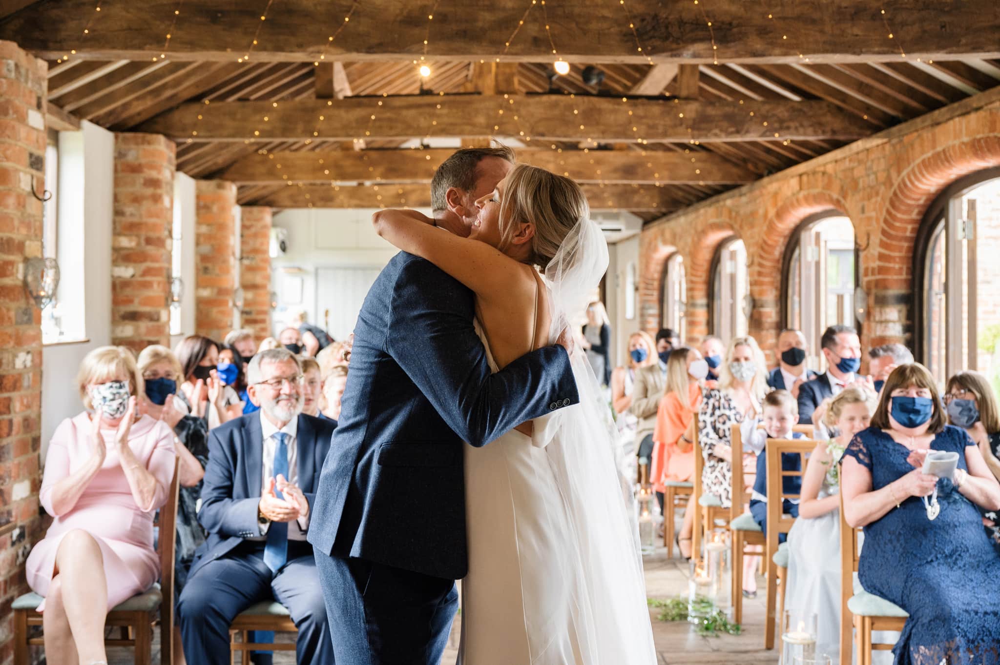 Couple hug at end of wedding ceremony at Dodmoor House