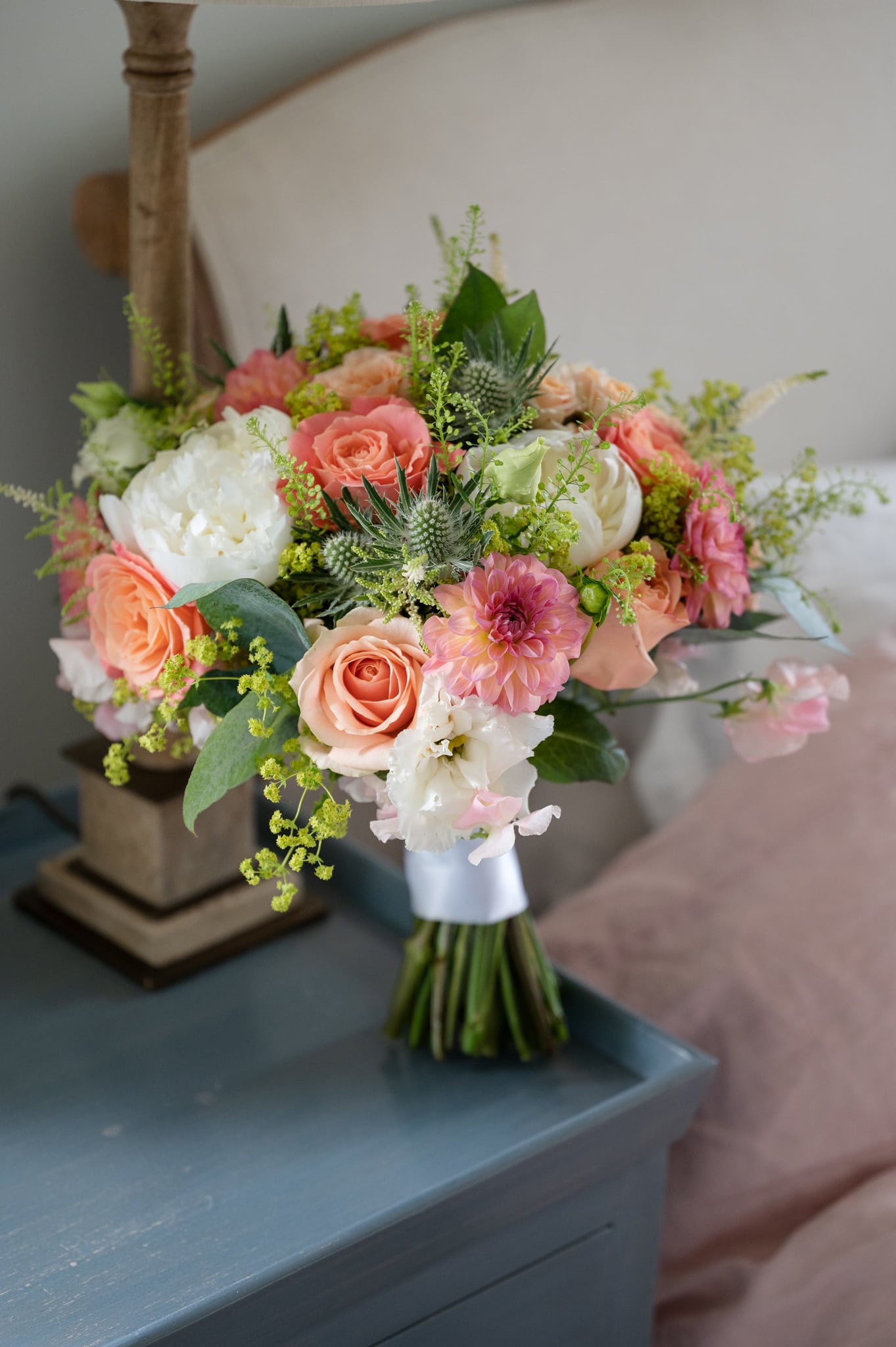 A bride's bouquet on a bedside table