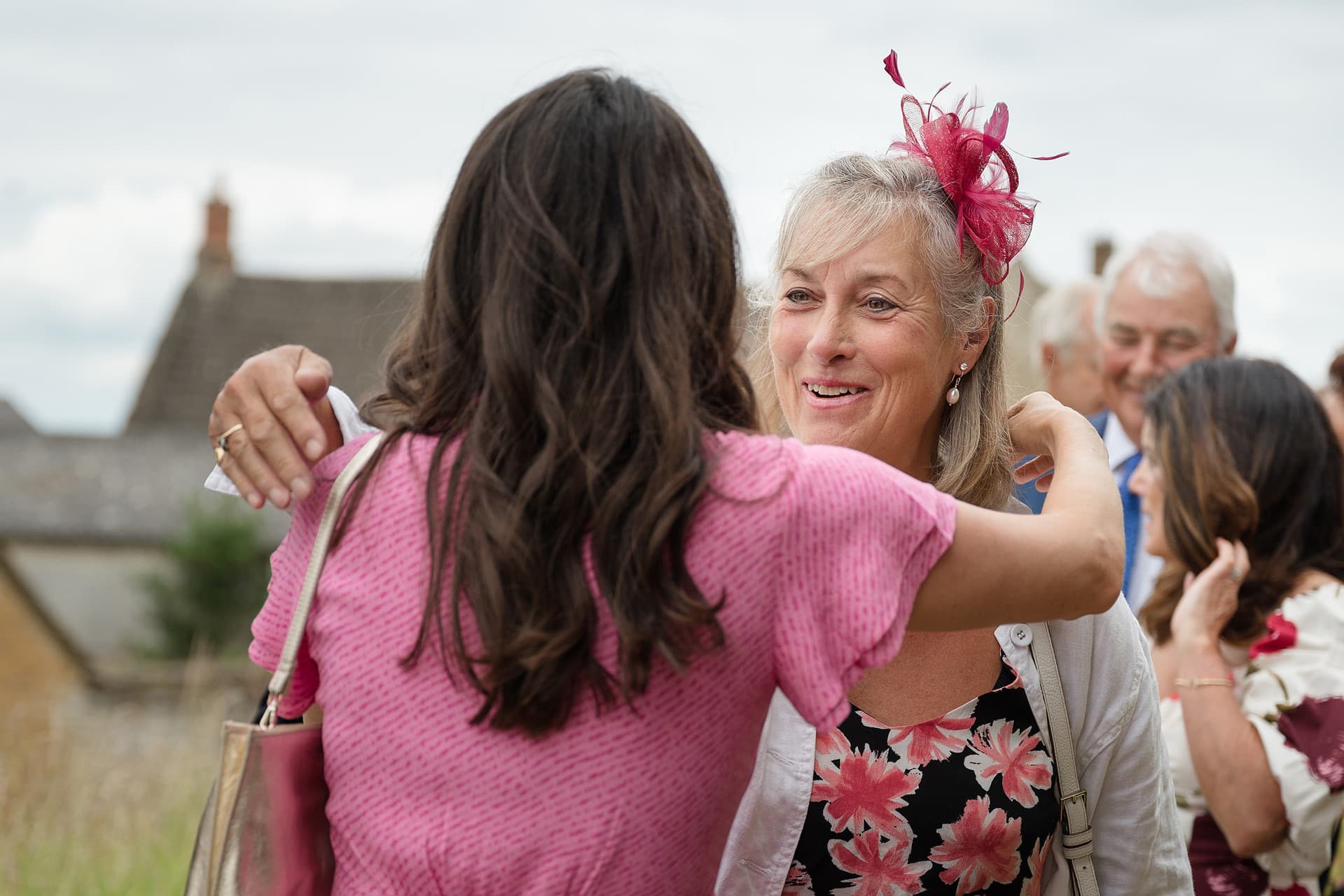 Wedding guests hugging each other outside Wing church in Rutland