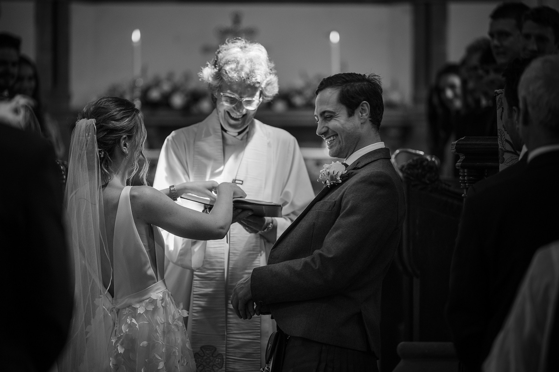 Groom laughing his head off as the bride tries to put his wedding ring on too soon