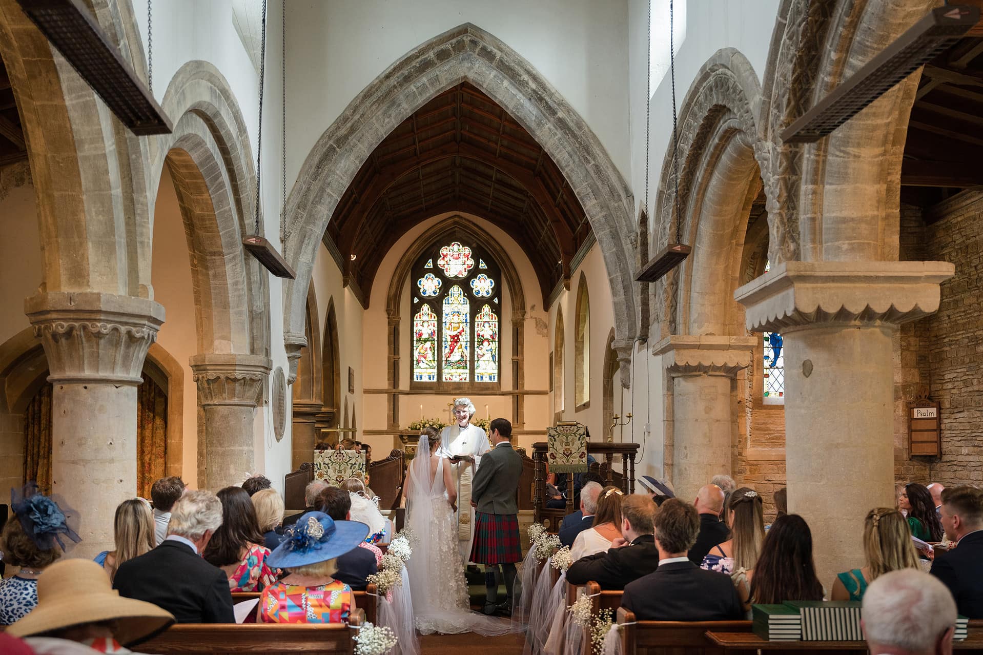 A wide angle view of the inside of Wing church in Rutland during a wedding ceremony