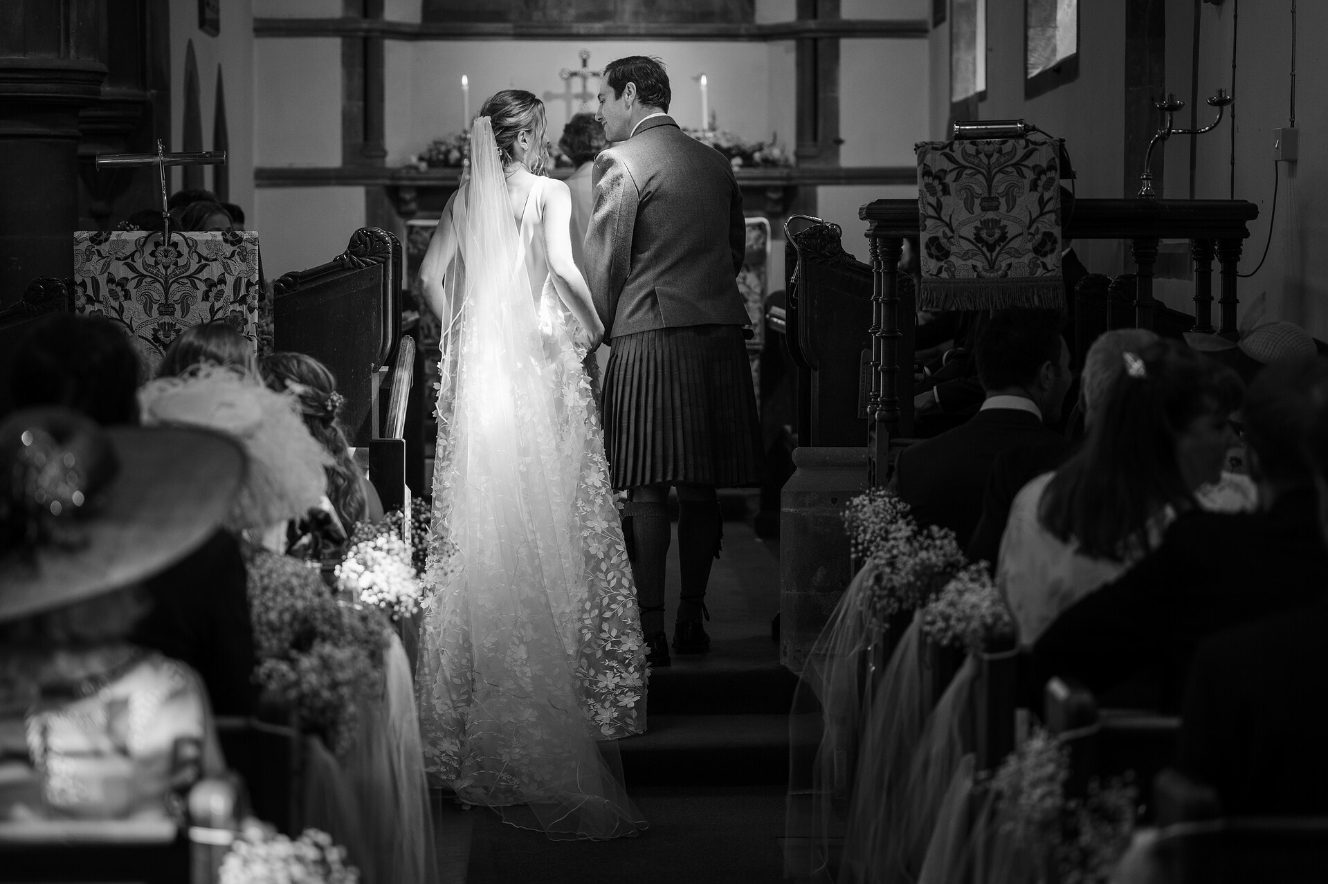 The sun highlighting the bride's dress during a marriage ceremony at Wing church in Rutland