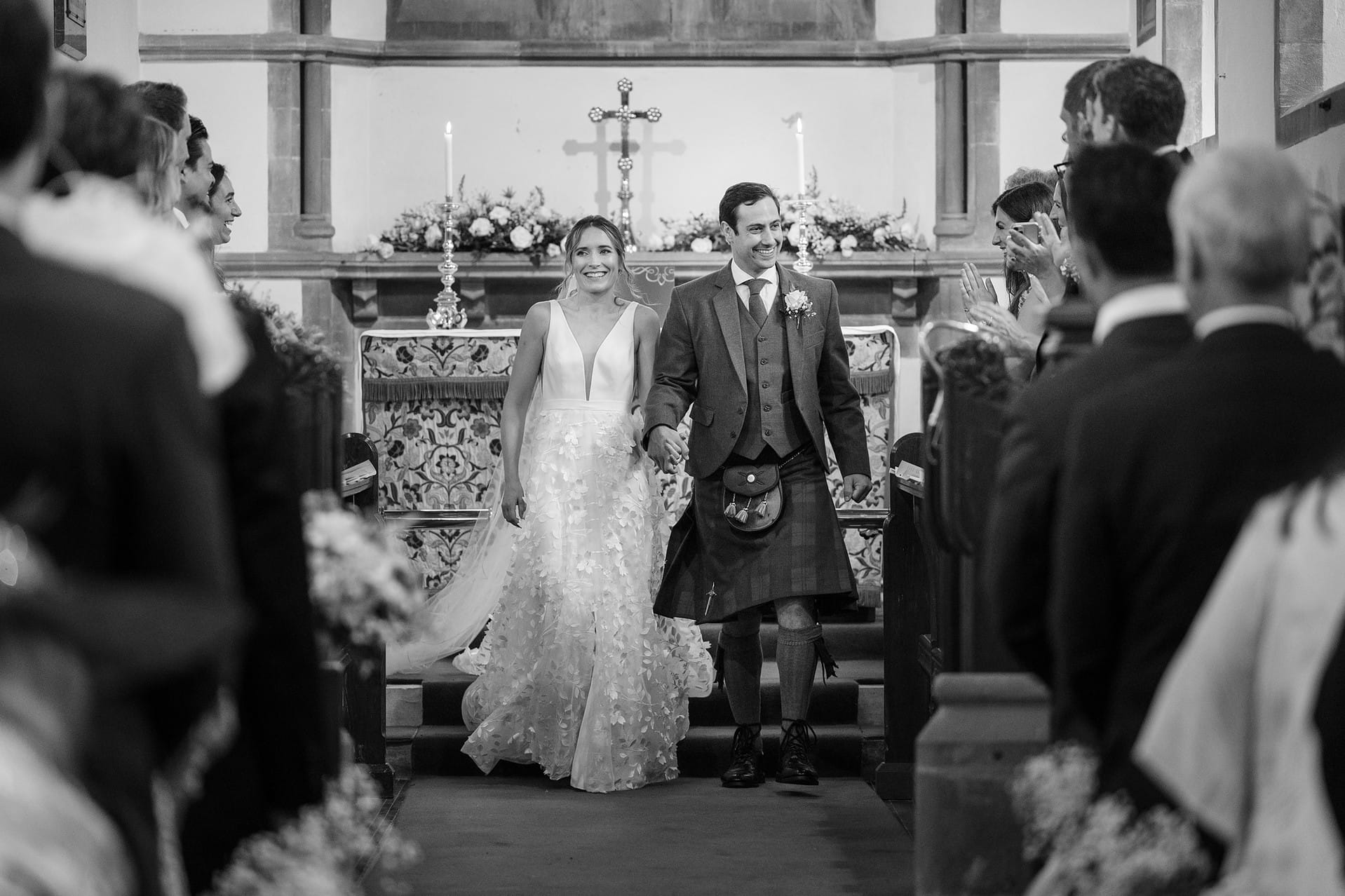 Bride and groom walking down the aisle after their wedding ceremony at Wing church in Rutland