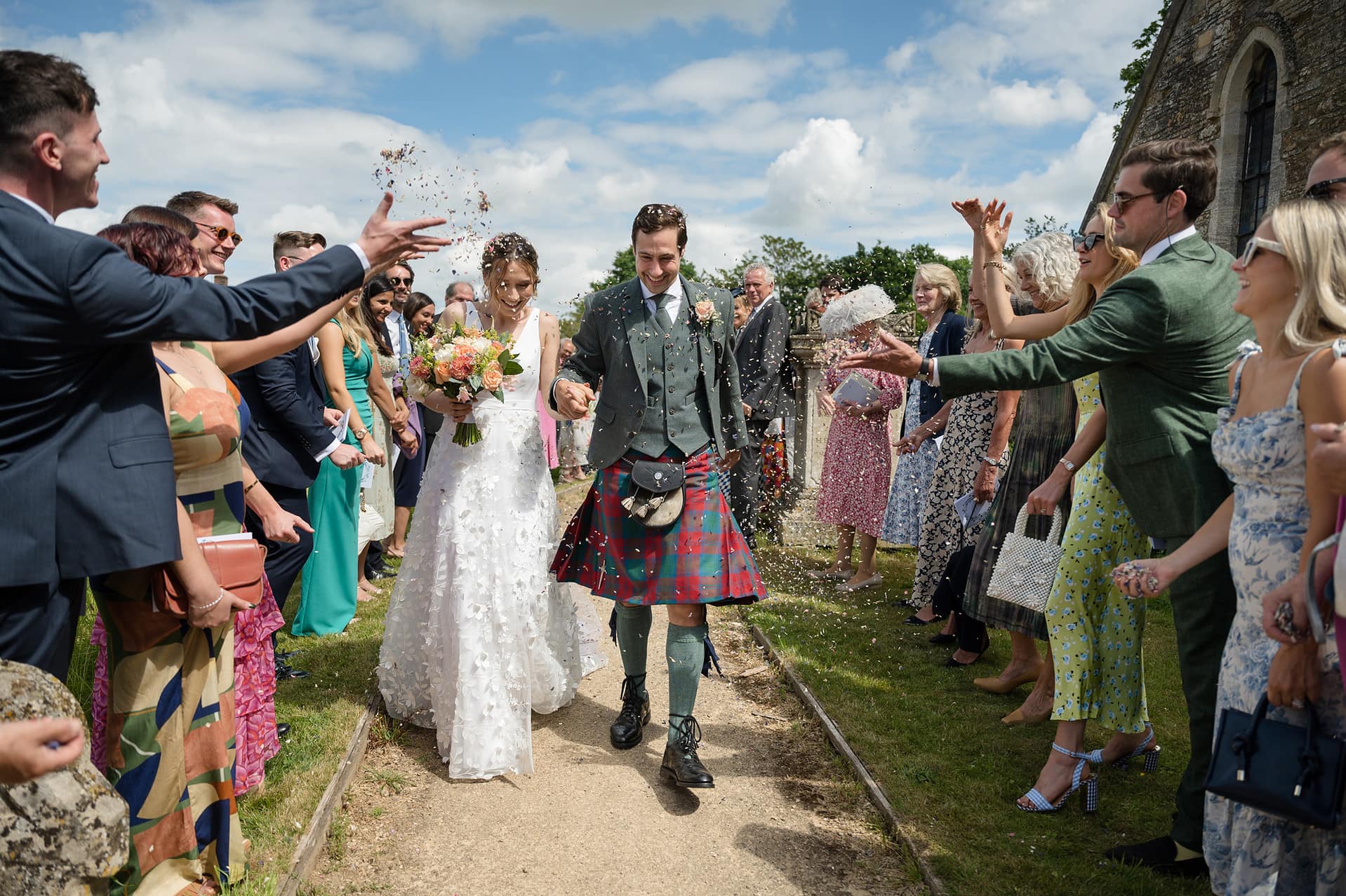 Confetti being thrown over the bride and groom at Wing church in Rutland