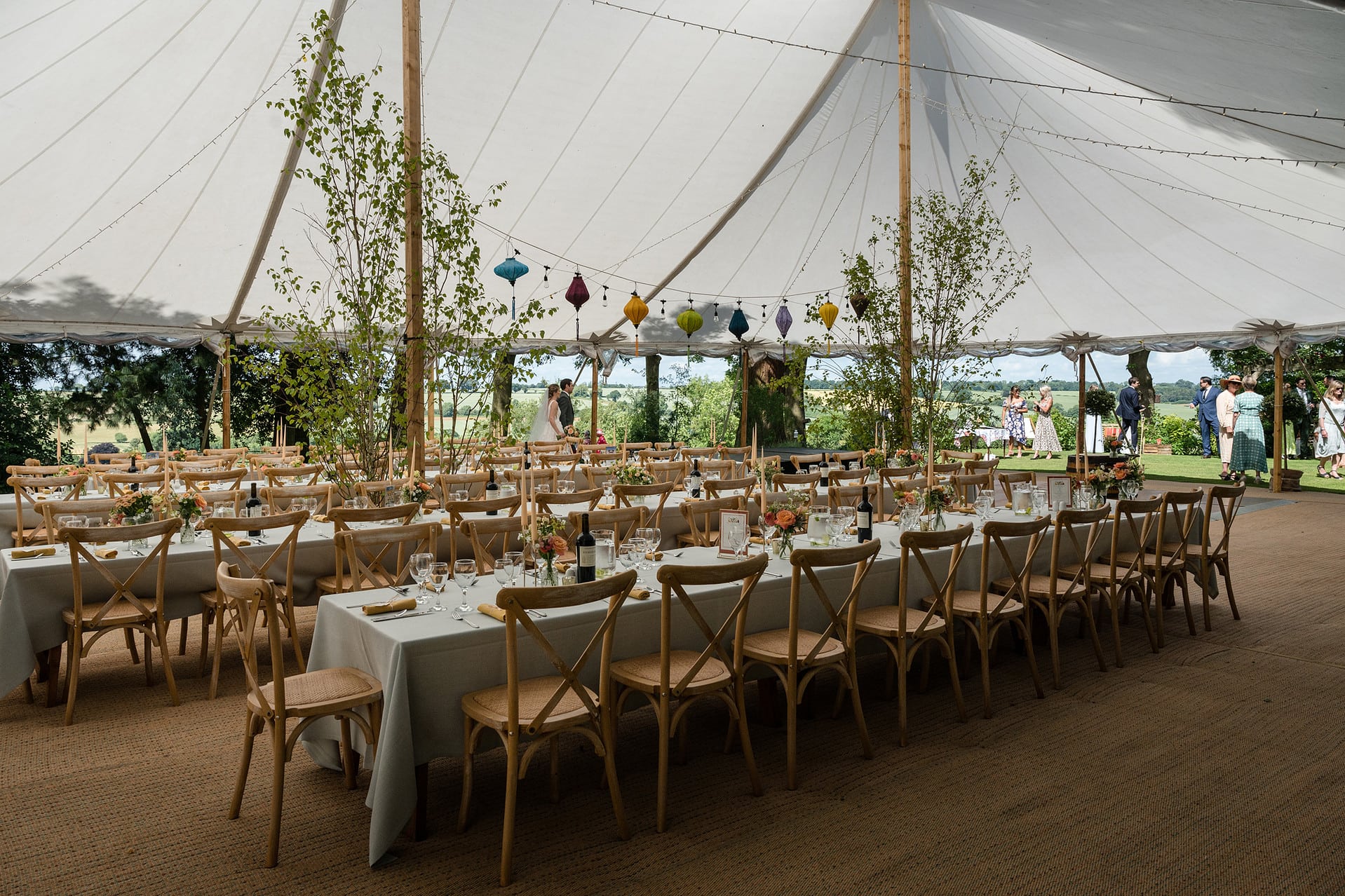 The interior of a sailcloth marquee looking out onto the Rutland countryside