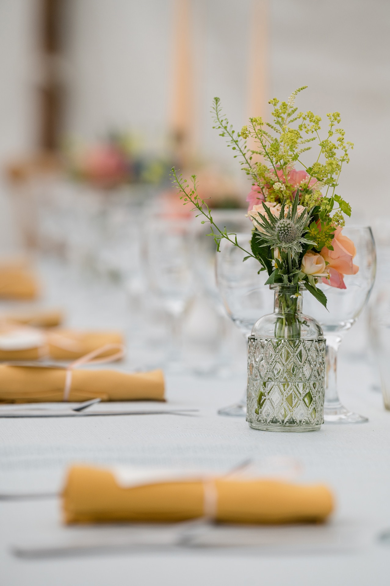 Rose and thistle bud vases on the dinner table