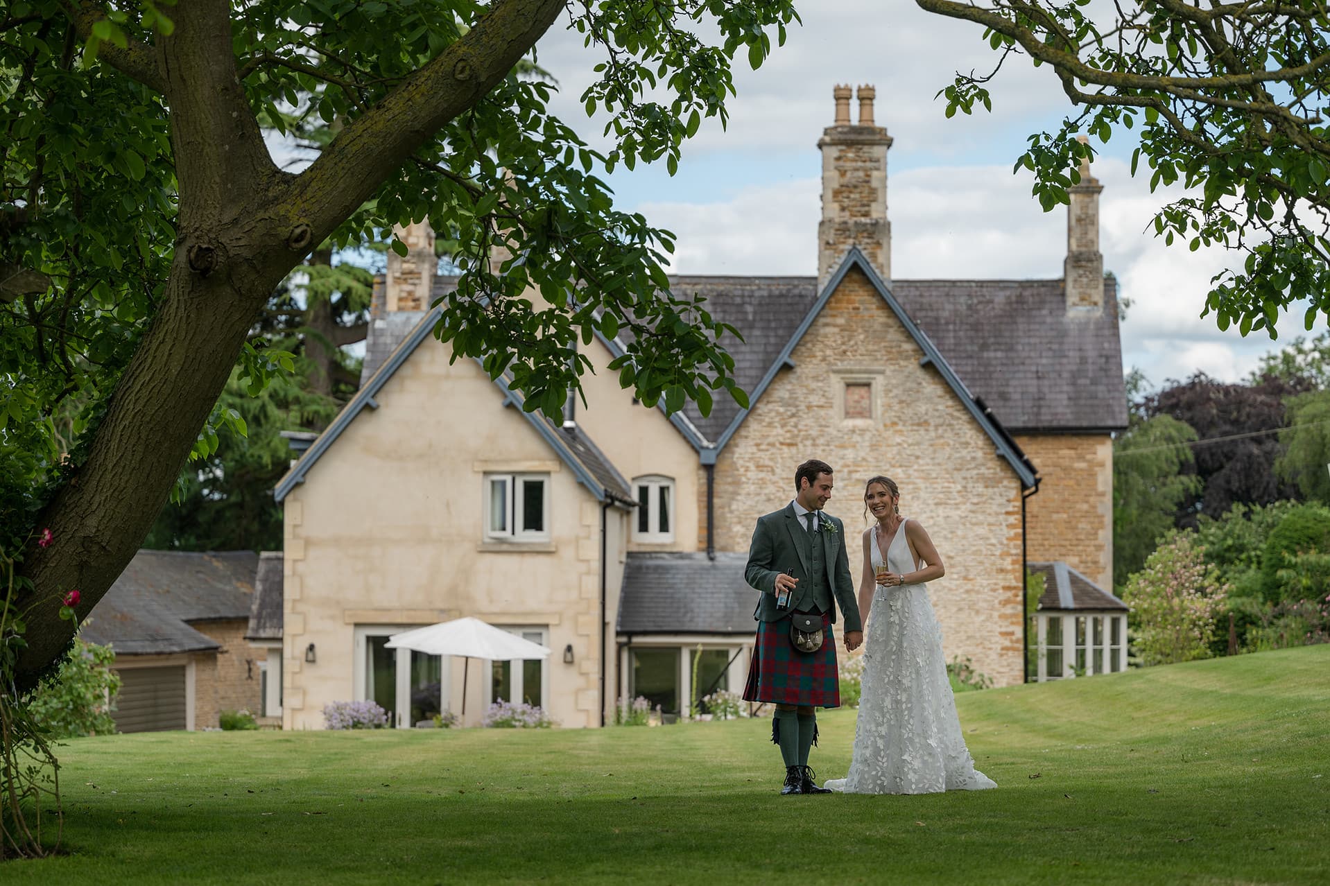 The bride and groom waiting alone in front of their house before being called in for the wedding breakfast