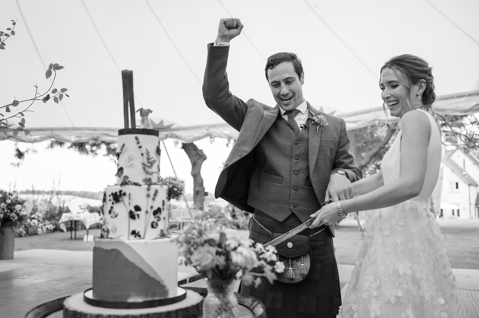 The bride and groom cutting their wedding cake