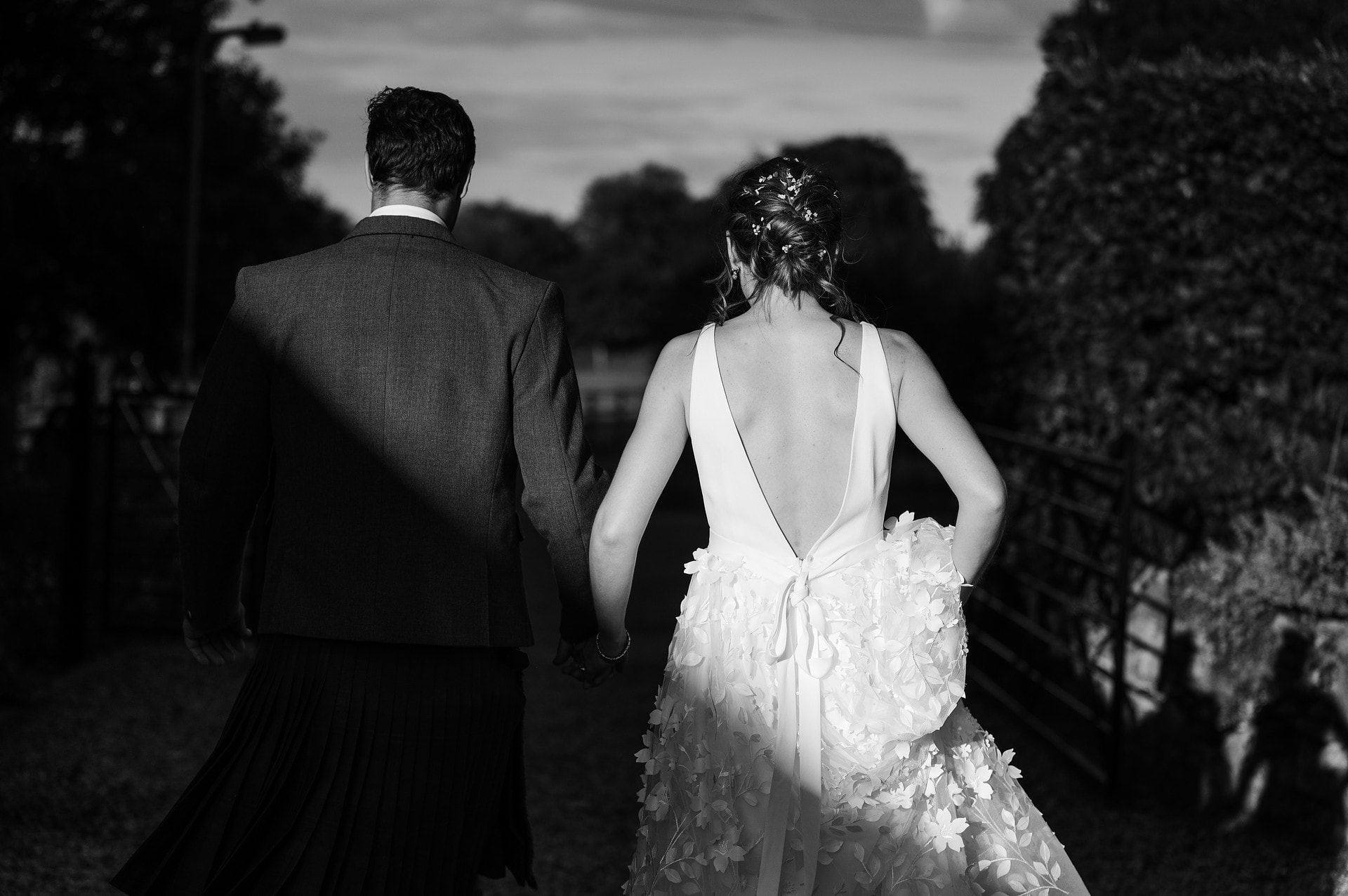 Back of bride's wedding dress lit by the sun