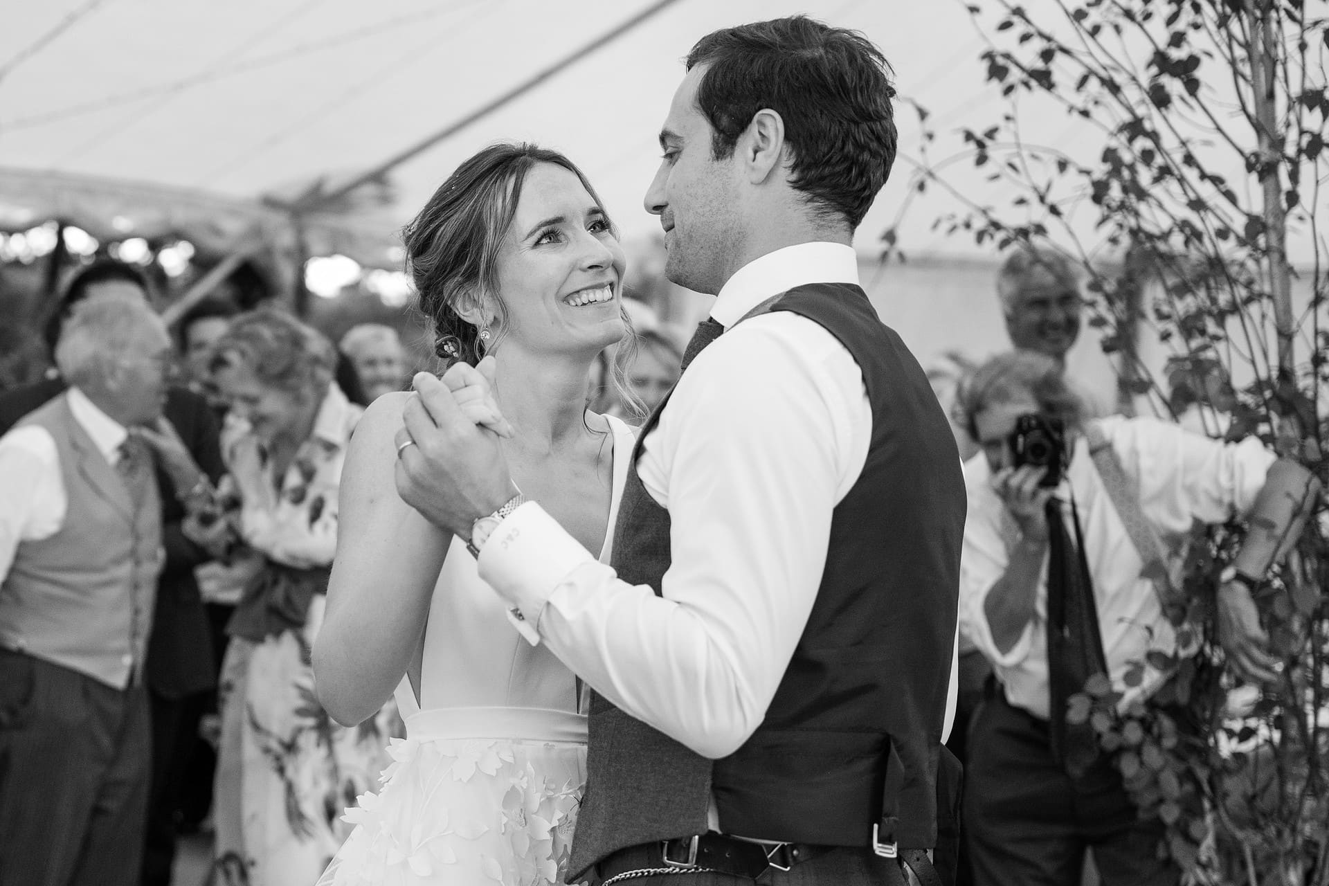 Bride smiling at the groom as they do their first dance